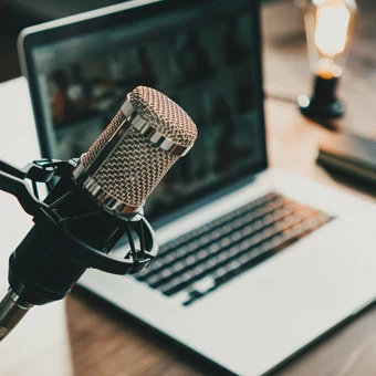 a professional microphone with a laptop in the background